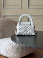 Chanel quilted mini handbag in white with gold CC logo, front view