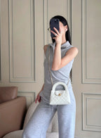 Chanel quilted mini handbag in white worn crossbody with gold chain strap