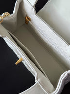 Chanel quilted mini handbag interior in white with gold clasp hardware