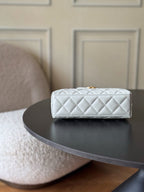 Chanel quilted mini handbag in white with gold hardware, rear view