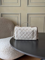 Chanel quilted white flap bag with gold logo, chain crossbody strap