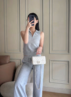 Chanel white quilted flap bag worn crossbody with chain strap