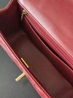 Burgundy leather Chanel handbag interior with zip pocket and stitched lining