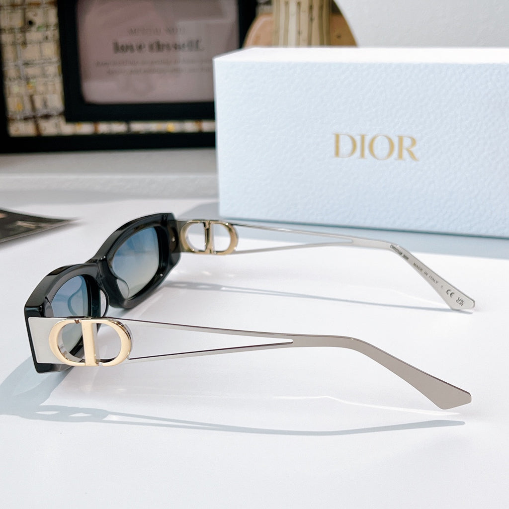 Dior sunglasses, black frame with gold-tone arms and dark lenses, side view