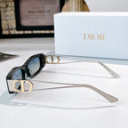 Dior sunglasses, black frame with gold-tone arms and dark lenses, side view