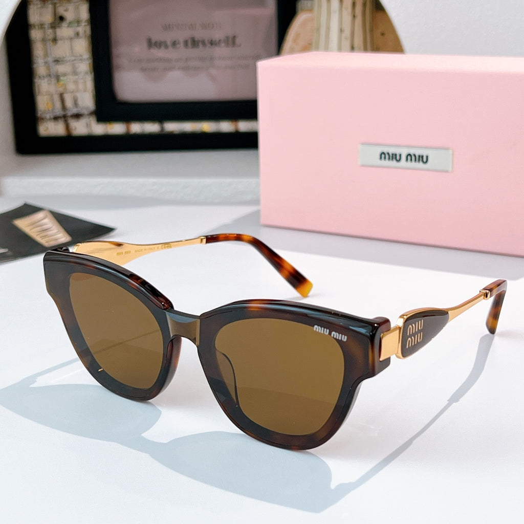 MiuMiu cat-eye sunglasses with tortoiseshell frames and gold-tone temples, amber tinted lenses