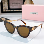 MiuMiu cat-eye sunglasses with tortoiseshell frames and gold-tone temples, amber tinted lenses