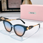 MiuMiu cat-eye sunglasses with dark blue frames and gold-tone temples, tinted lenses