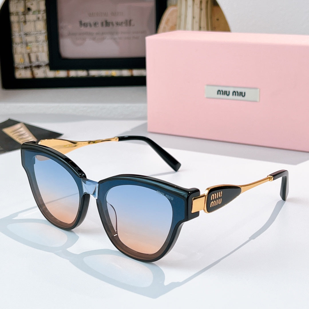MiuMiu cat-eye sunglasses with dark blue frames and gold-tone temples, tinted lenses