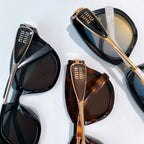 MiuMiu sunglasses pair with black and tortoiseshell frames, gold-tone details, tinted lenses