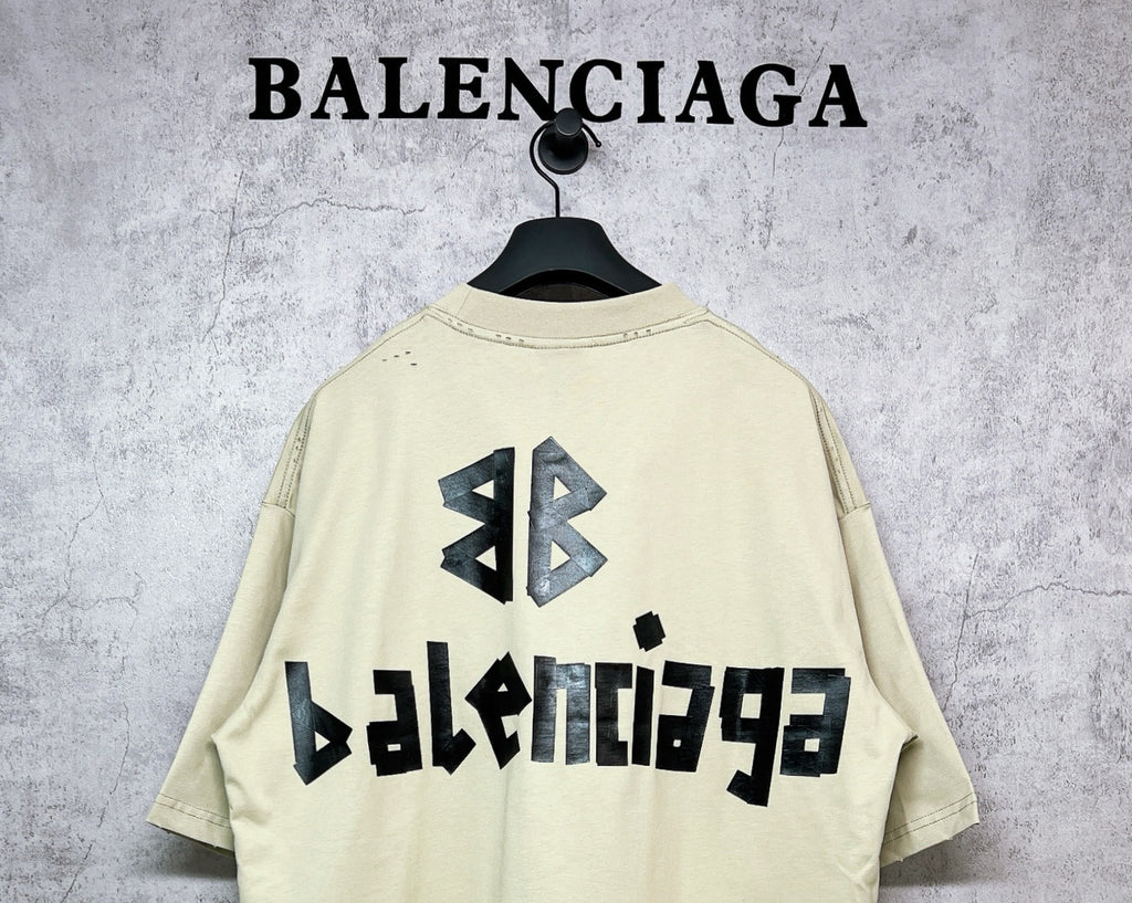 Balenciaga short-sleeve T-shirt, pale yellow with black back emblem and text