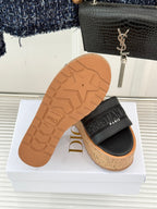 Black platform slide sandal outsole with star tread and cork midsole
