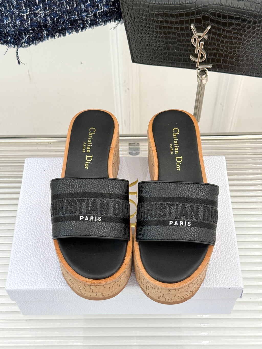 Black platform slide sandals with wide logo band straps and cork footbed