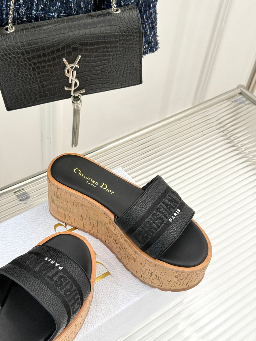Black platform slide sandals with embossed strap detail and cork wedge sole