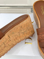 Close-up of tan cork platform sandal with printed footbed and open toe