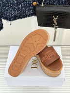 Tan slide sandals with cork sole and outsole tread, open toe