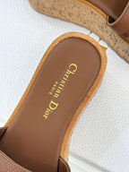 Close-up of brown slide sandal footbed with Dior lettering