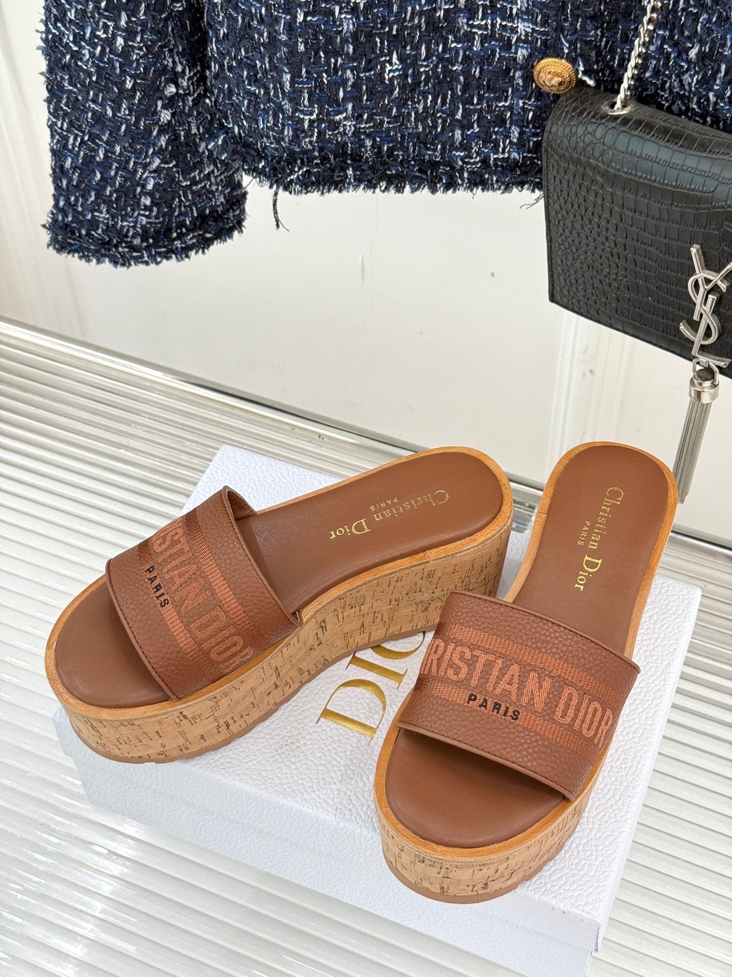 Brown platform slide sandals with cork sole and wide logo strap, open toe