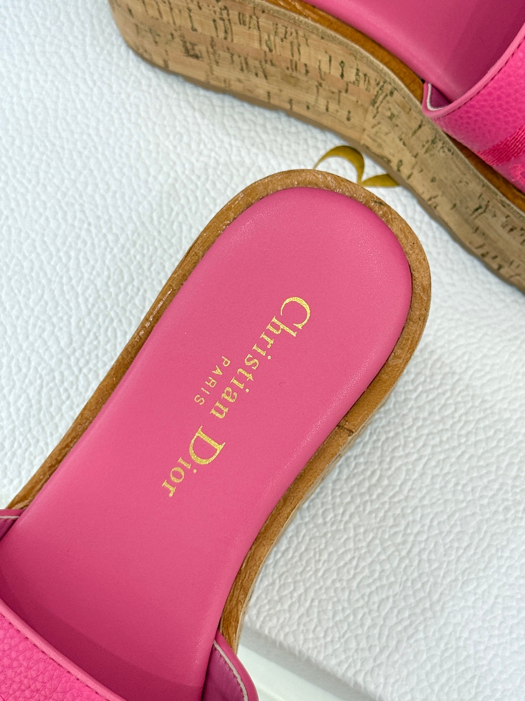 Close-up of pink Dior slide sandal footbed with gold “Dior” text