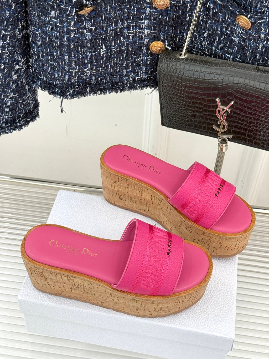 Pink Dior slide sandals with wide front strap and cork-look platform wedge