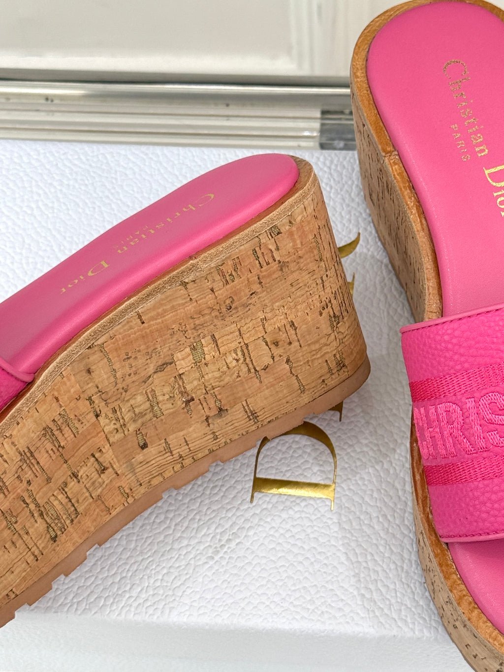 Close-up: pink Dior slide sandal with textured strap and cork-look platform