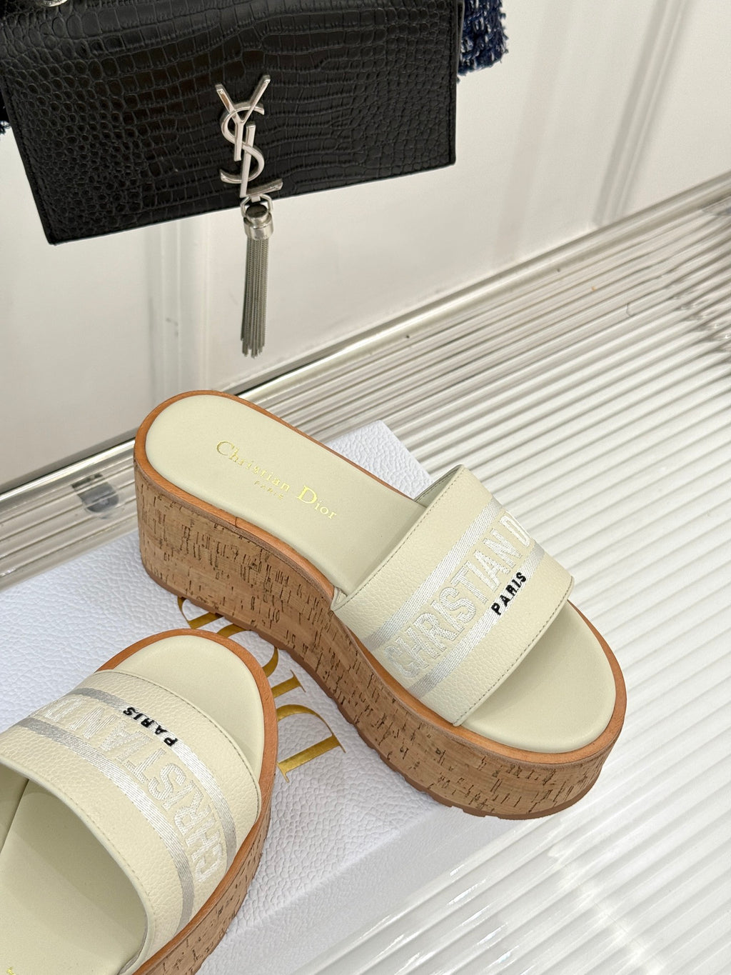 Dior platform slide sandal with cream strap and cork wedge, side profile view