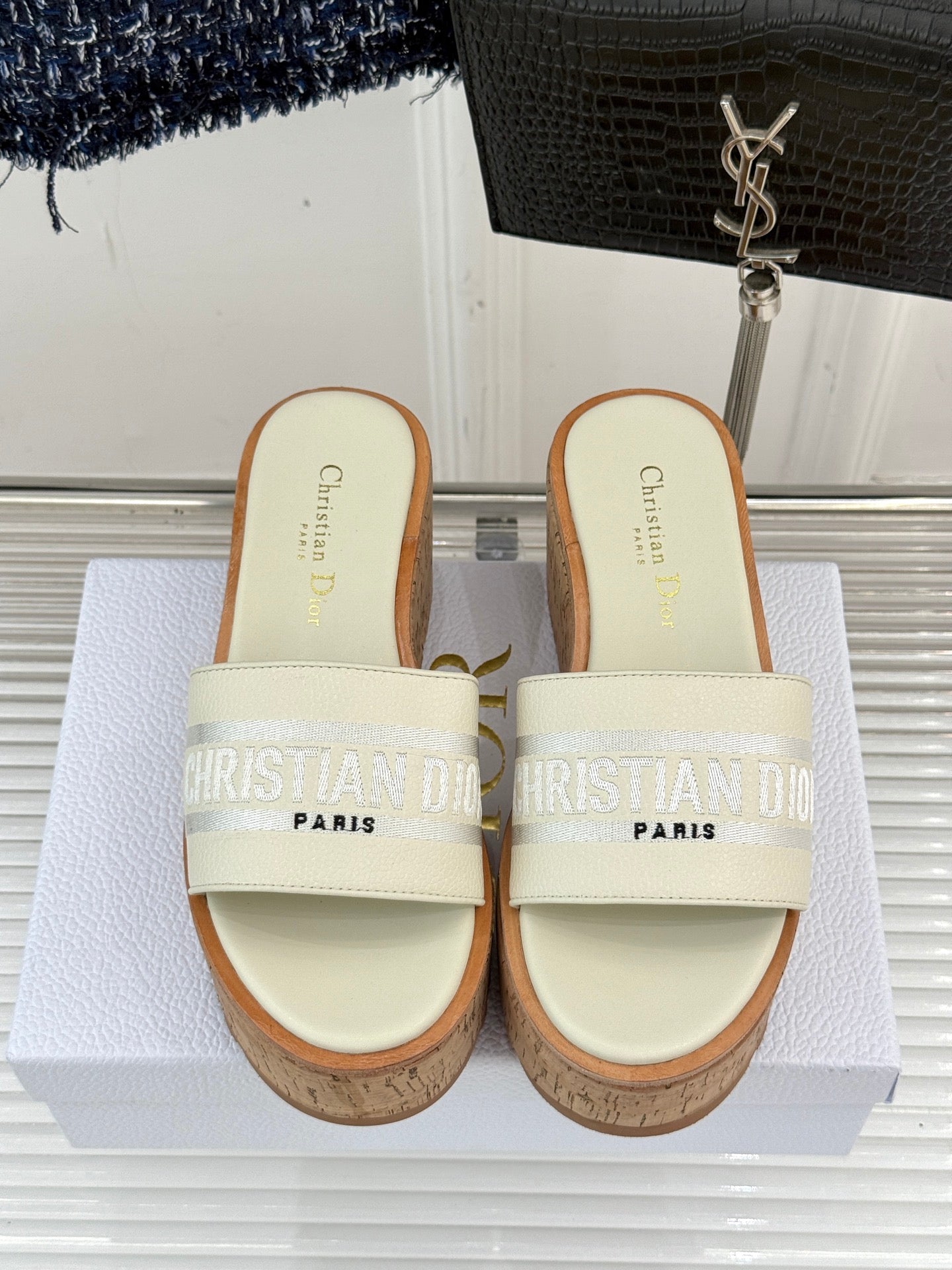 Dior platform slide sandals viewed from front with cream straps and cork soles