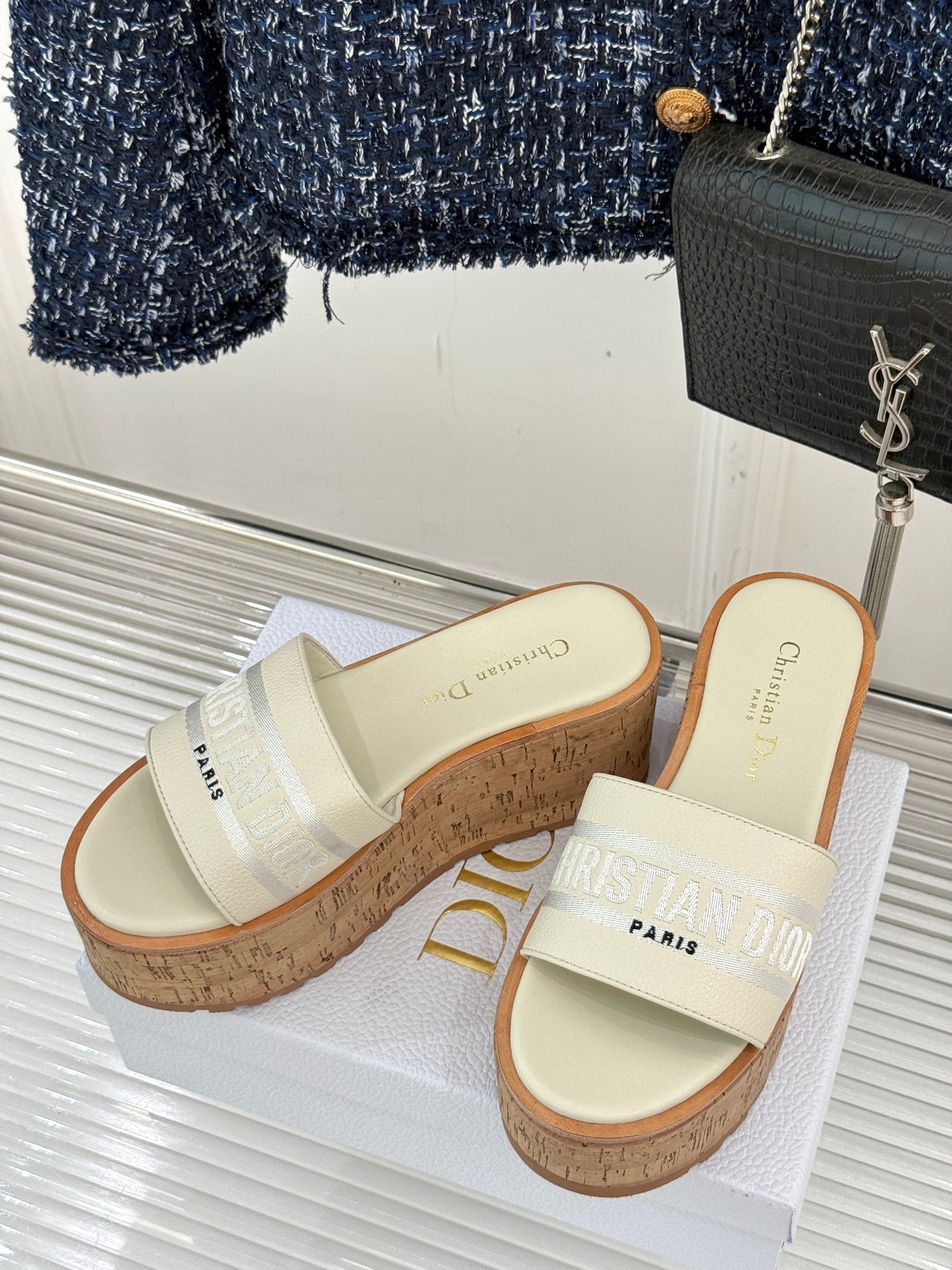Dior platform slide sandals with cream straps, cork wedges, and side branding