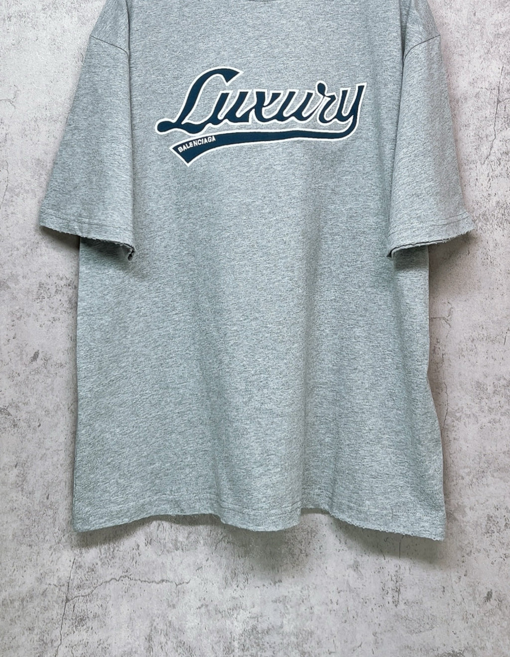 Balenciaga heather gray T-shirt with “Luxury” logo across the chest
