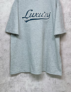Balenciaga heather gray T-shirt with “Luxury” logo across the chest