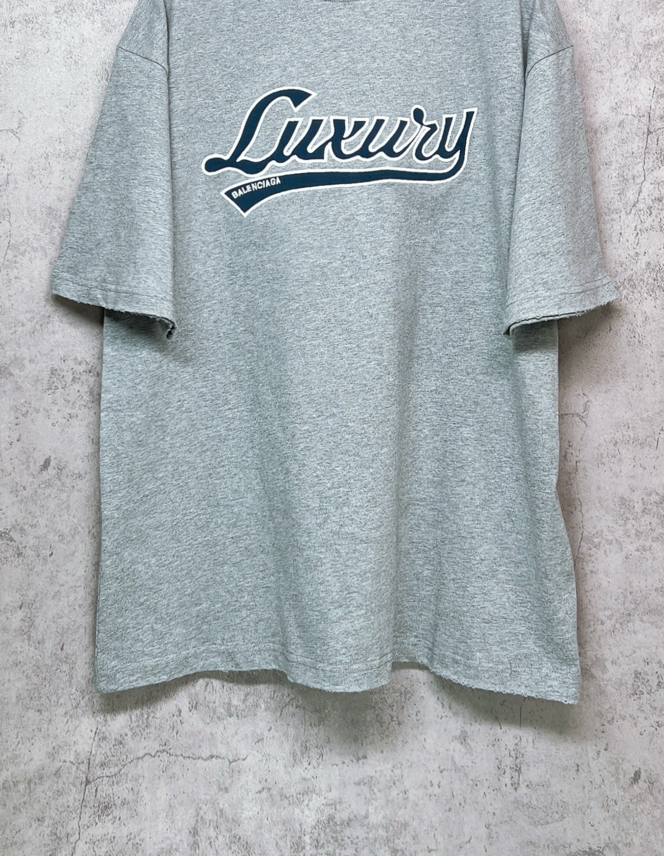 Balenciaga heather gray T-shirt with “Luxury” logo across the chest