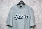 Balenciaga heather gray T-shirt with large “Luxury” logo graphic