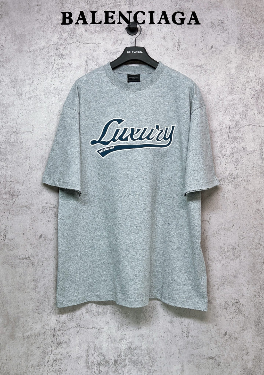Balenciaga heather gray T-shirt with “Luxury” logo graphic on the chest