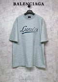 Balenciaga heather gray T-shirt with “Luxury” logo graphic on the chest