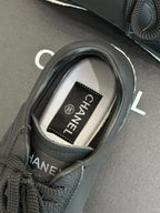 Close-up of dark sneaker with CHANEL label inside the collar