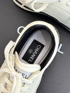 White sneaker with inner label showing CHANEL text