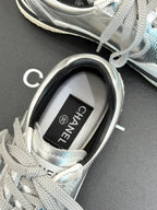 Close-up of sneaker tongue label reading CHANEL on the inner collar
