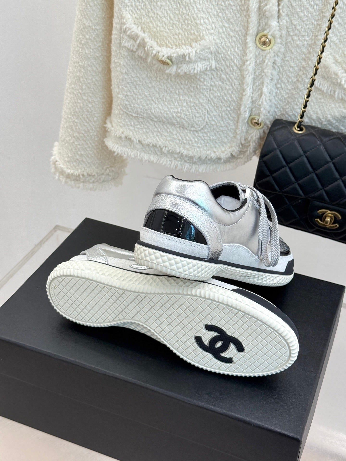 Chanel sneakers heel and sole view in metallic silver with textured outsole tread