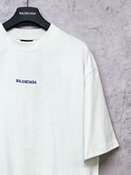 White crew-neck T-shirt with BALENCIAGA chest logo, short sleeves.
