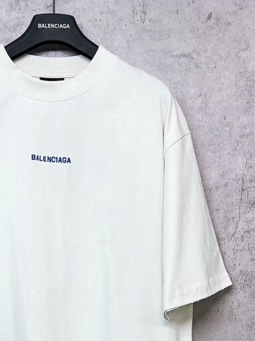 White crew-neck T-shirt with BALENCIAGA chest logo, short sleeves.