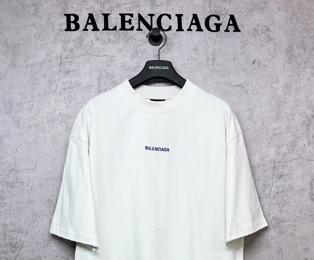 White crew-neck T-shirt with BALENCIAGA chest logo, short sleeves.