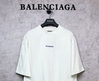 White crew-neck T-shirt with BALENCIAGA chest logo, short sleeves.