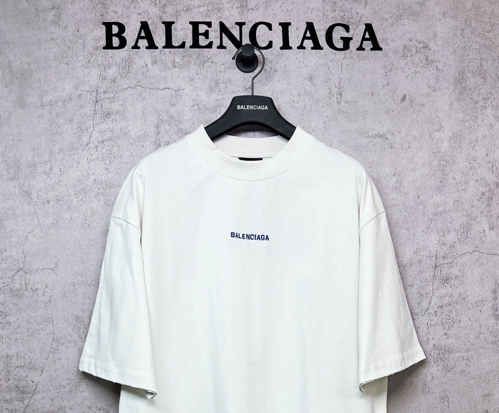 White crew-neck T-shirt with BALENCIAGA chest logo, short sleeves.