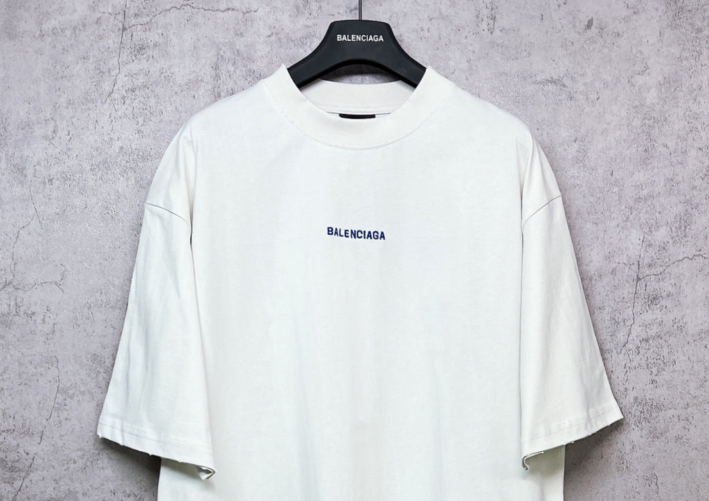 White crew-neck T-shirt with small BALENCIAGA chest print, short sleeves.