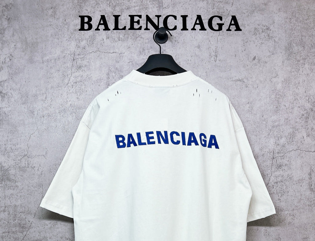 White crew-neck T-shirt with BALENCIAGA back logo, short sleeves.