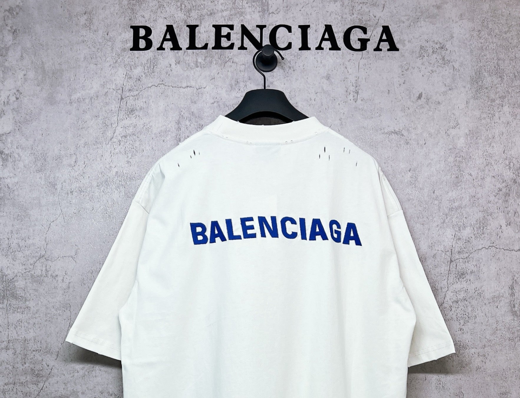 White crew-neck T-shirt with BALENCIAGA back logo, short sleeves.