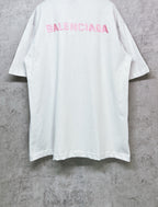 White short-sleeve crewneck T-shirt with pink BALENCIAGA logo on upper back