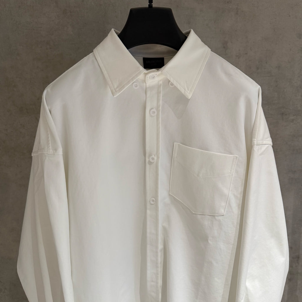White button-up shirt with pointed collar, front placket, chest pocket
