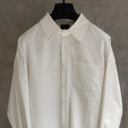 White button-up shirt with pointed collar, front placket, chest pocket