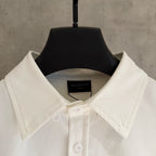 White shirt collar with button placket and Balenciaga neck label